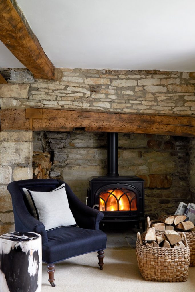 Exposed stone walls and original timber beams forming the backdrop to a calm interior, illustrating how starting with the architecture creates a timeless foundation.