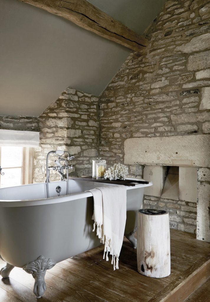 A bathroom designed to sit sensitively within the existing stone architecture, illustrating a considered interior response to the character of the building.