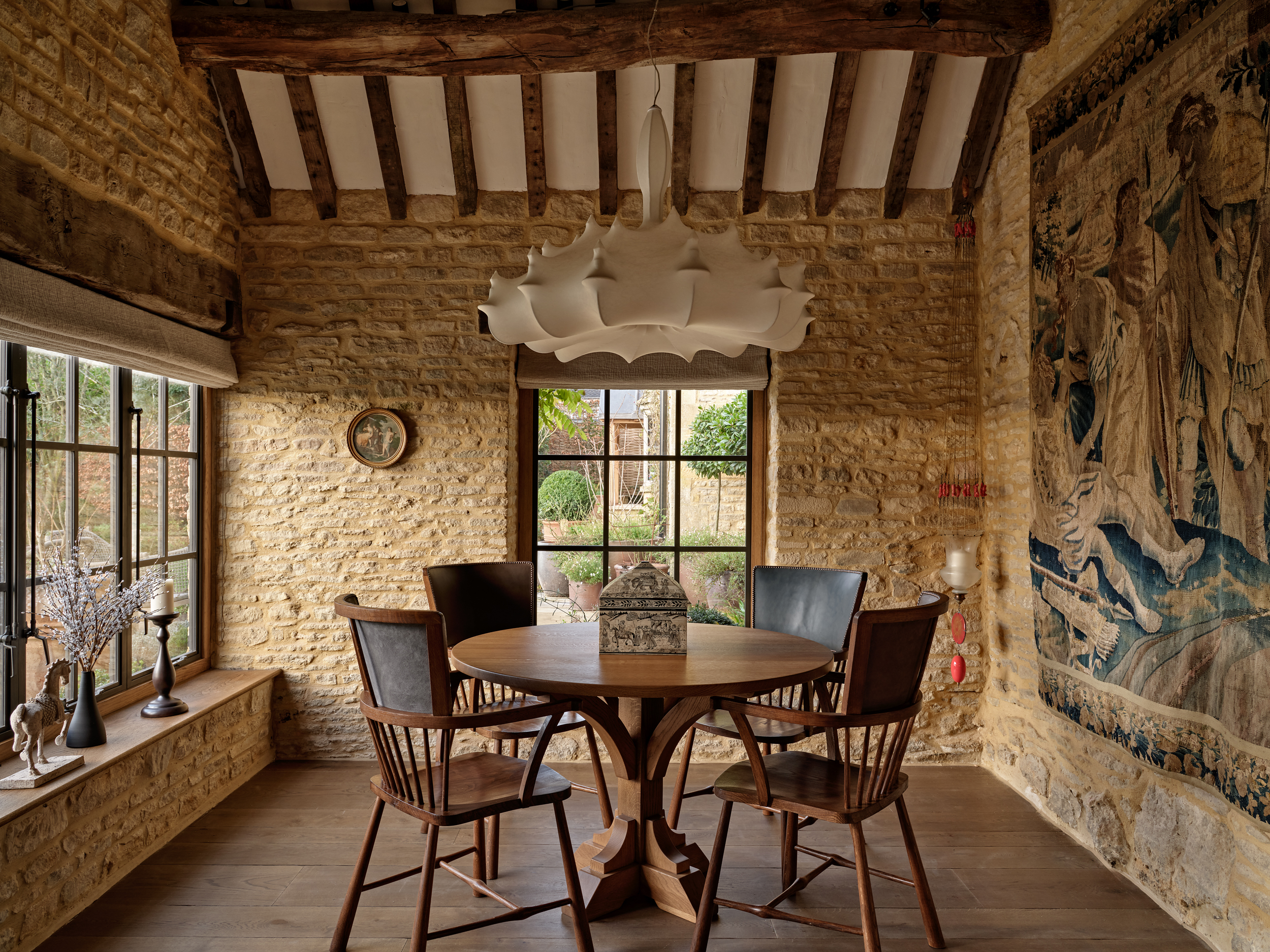 Cotswold stone dining room with exposed beams and natural light