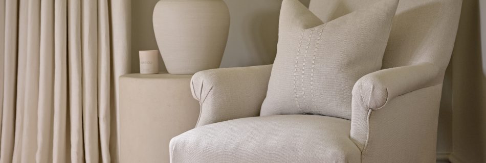 Studio Bellord timeless interior design featuring a classic upholstered armchair in a neutral palette